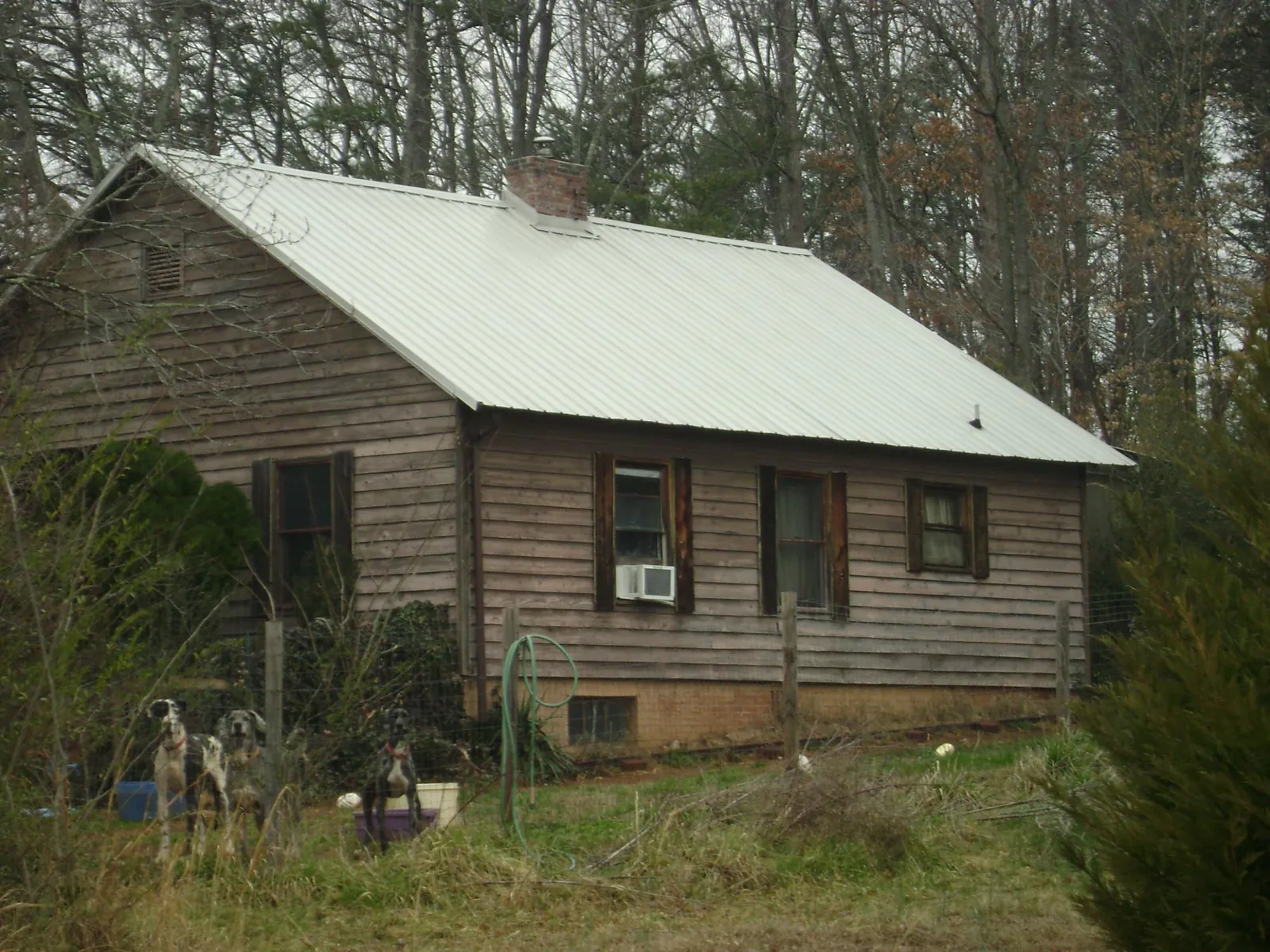 White metal roof on an old wood sided farmhouse, from a Metal Roof Installation job in Coinjock